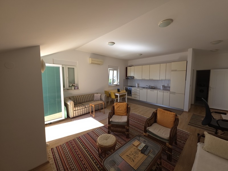 Open living area with kitchen and patio door