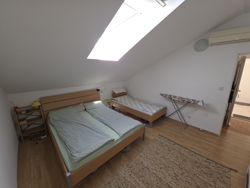 Bedroom with skylight and air conditioning