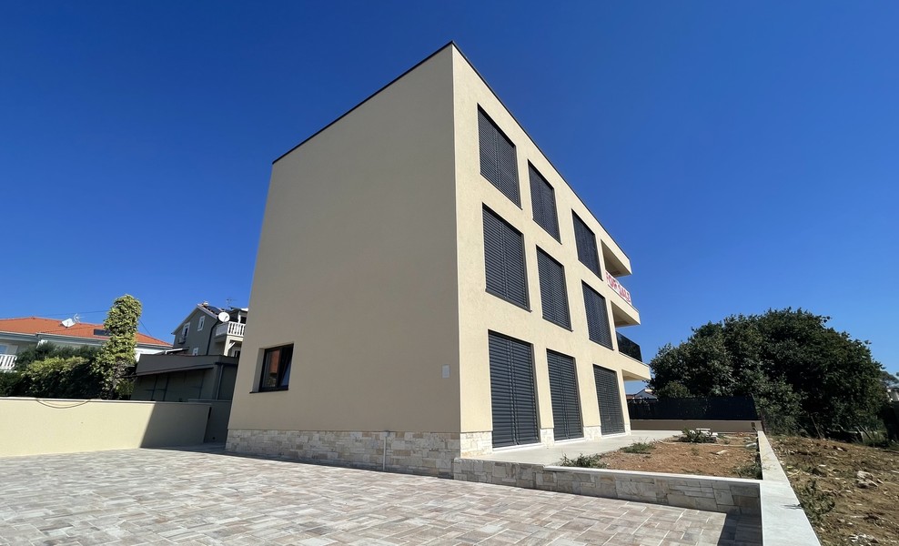 Side view of the new building with paved courtyard