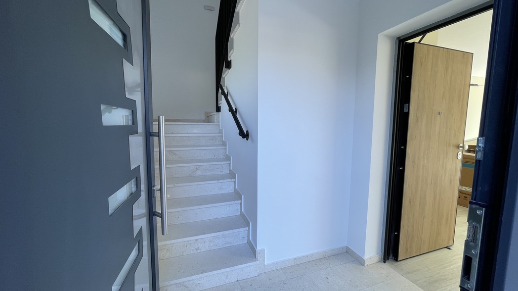 Stairwell and apartment door on the ground floor