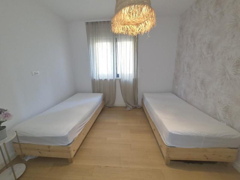 Second bedroom with curtains on the window