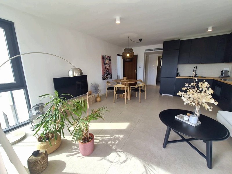 Open living area with kitchen in the background