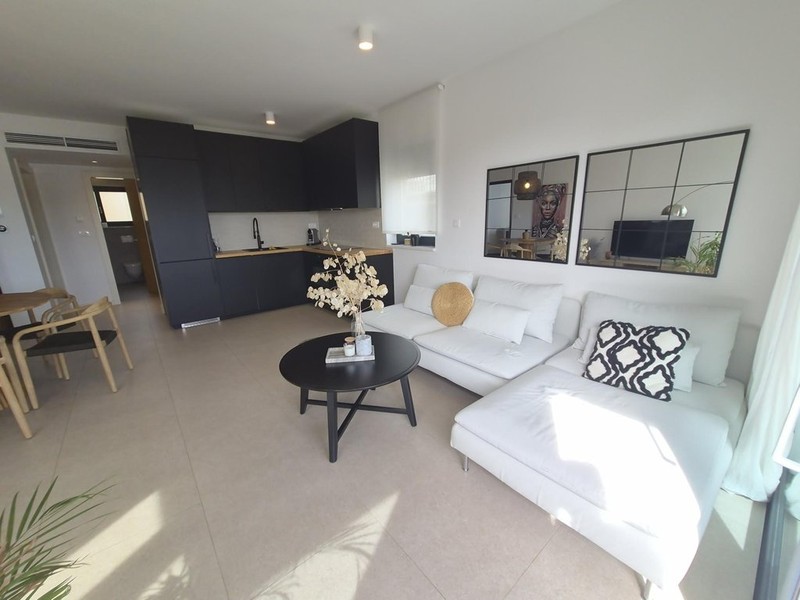 Living room with white sofa and kitchenette