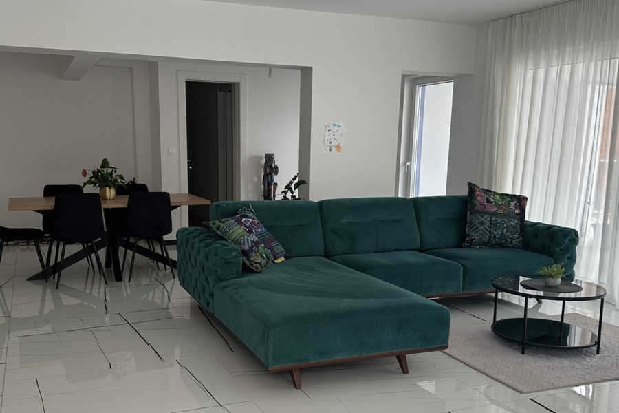 Living room with corner sofa and large windows