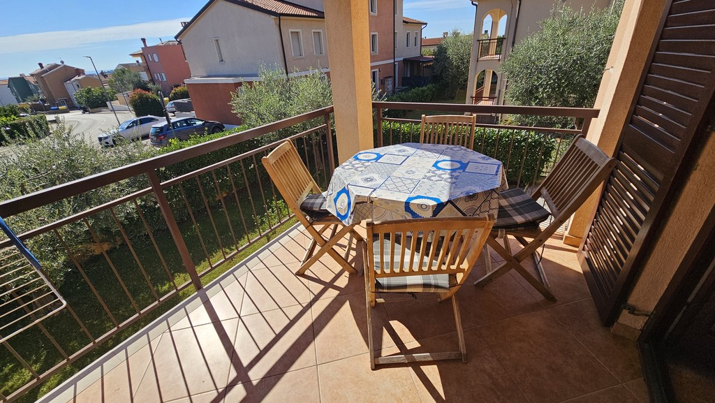 Balcony with seating area and view of greenery
