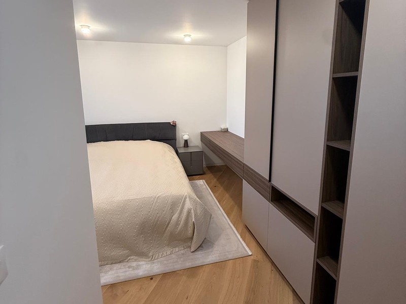 Bedroom with built-in wardrobe and wooden floor
