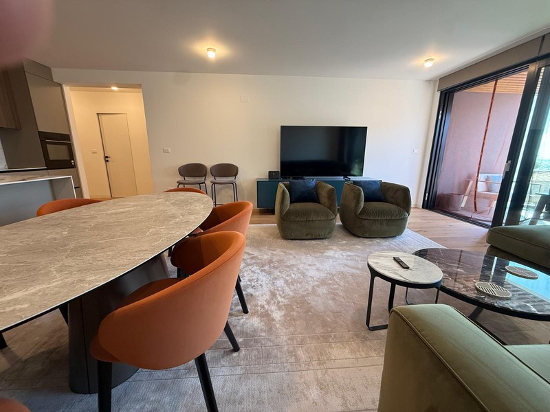 Oval dining table in front of the living area