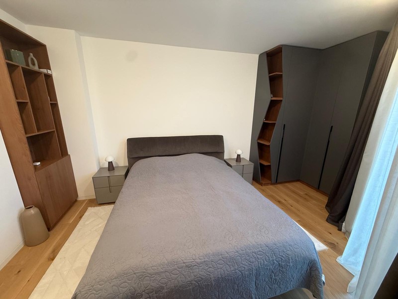 Bedroom with double bed and shelving wall