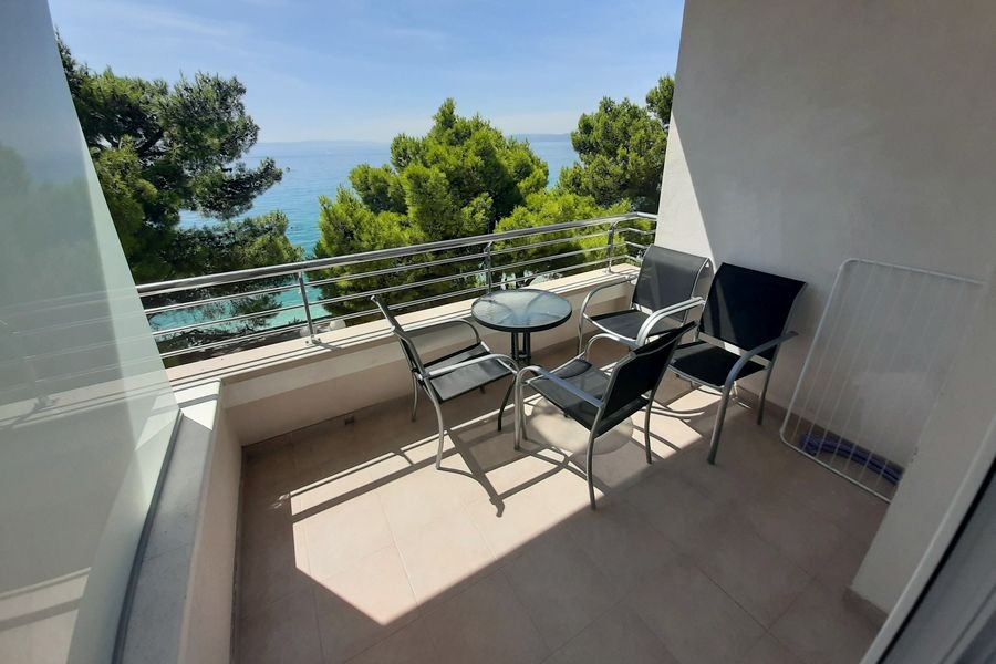 Terrace with seating area and view of the sea
