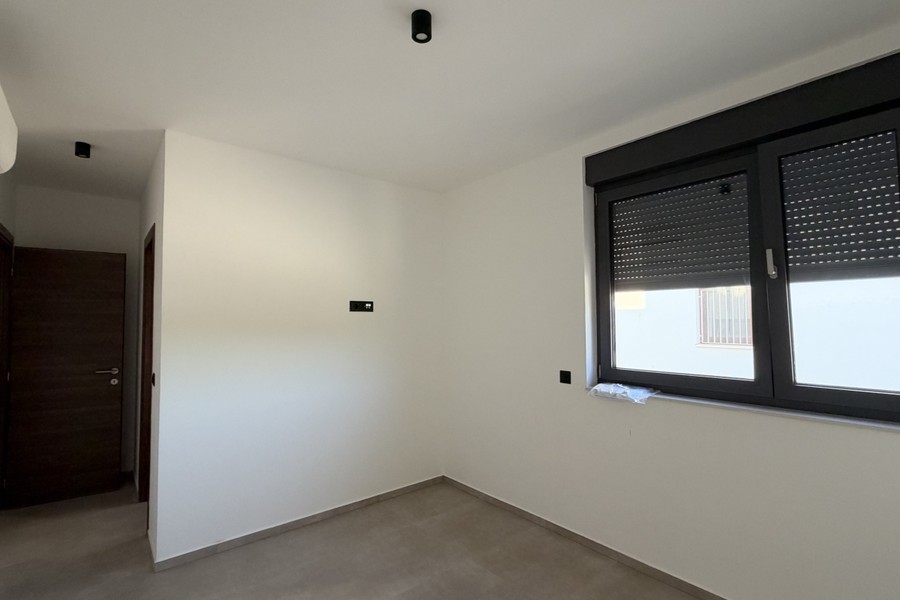 Bedroom with window and roller shutter
