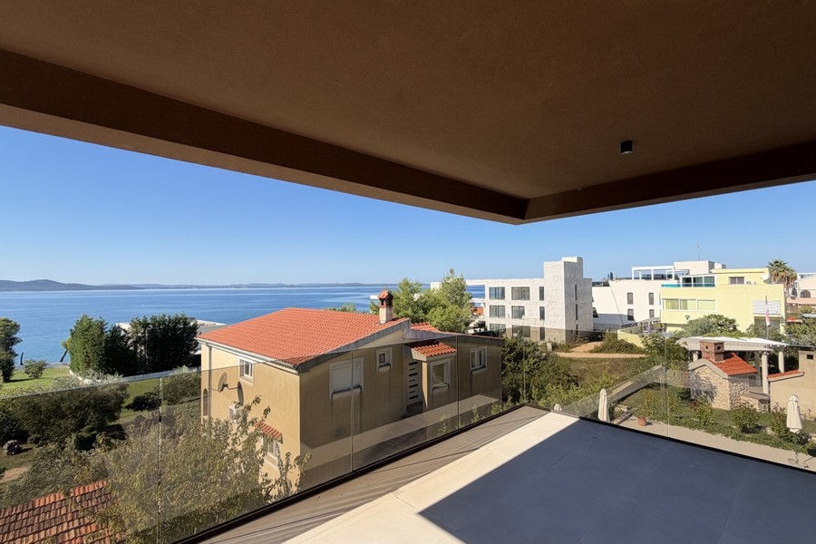 Balcony with glass balustrade and view over the bay