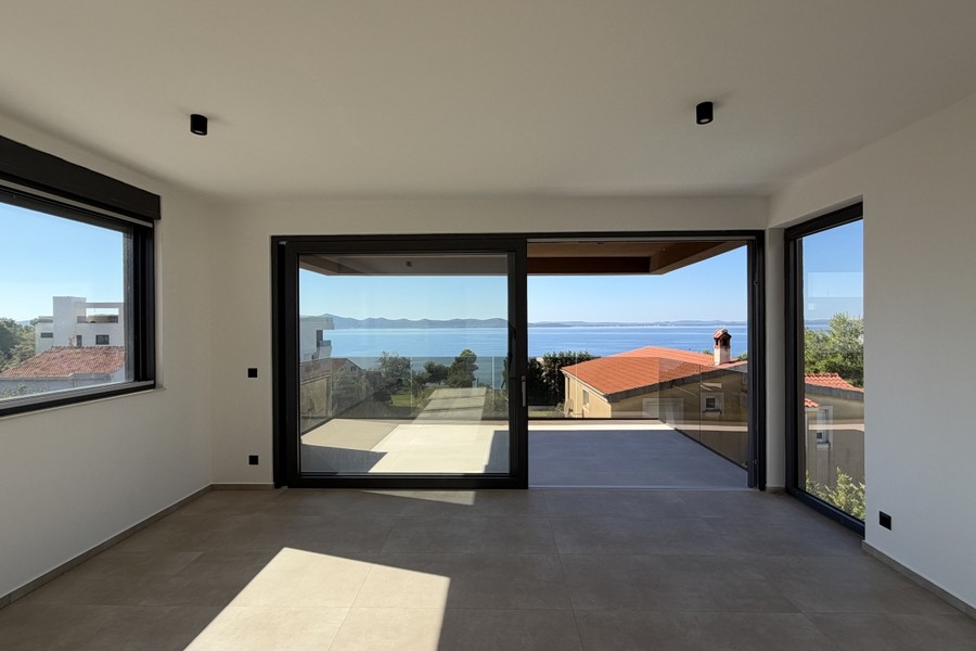 Living area with large windows facing the balcony