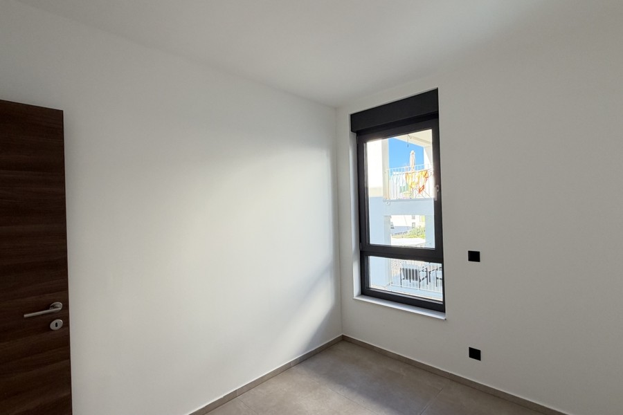 Bedroom with window and wooden door