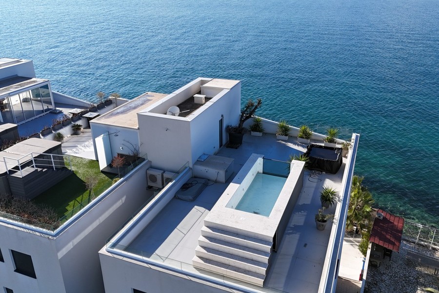 Building by the water with pool on the roof terrace