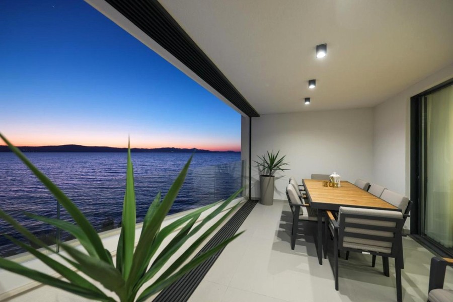 Loggia with dining table and view of the sea