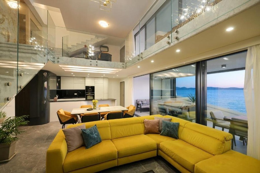 Living room with gallery and yellow corner sofa