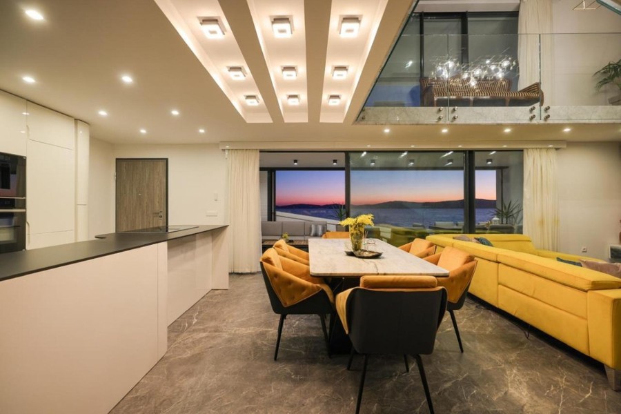 Dining area with kitchen and view of the sea