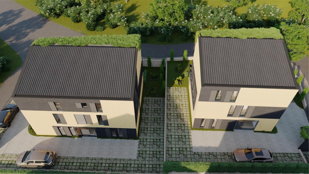 Aerial view of two buildings with green roofs and parking spaces