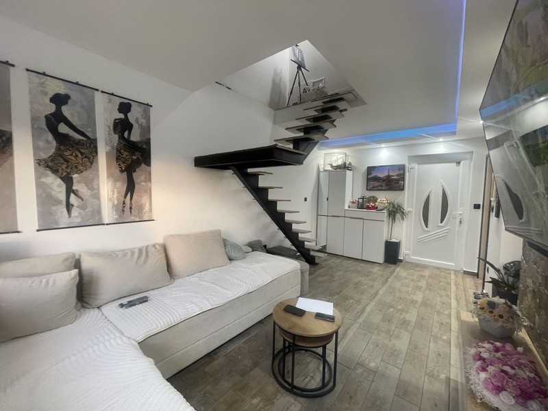 Living area with staircase to the attic floor