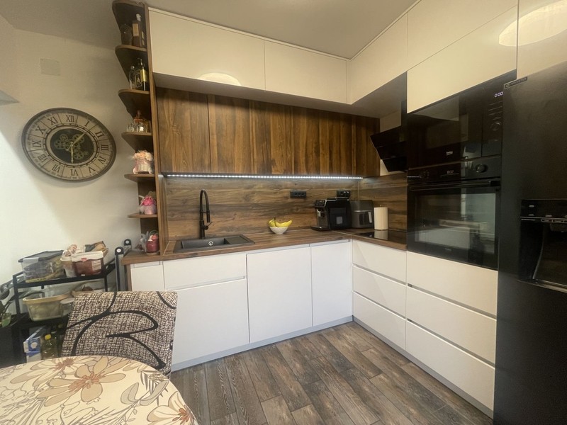 Fitted kitchen with dark worktop
