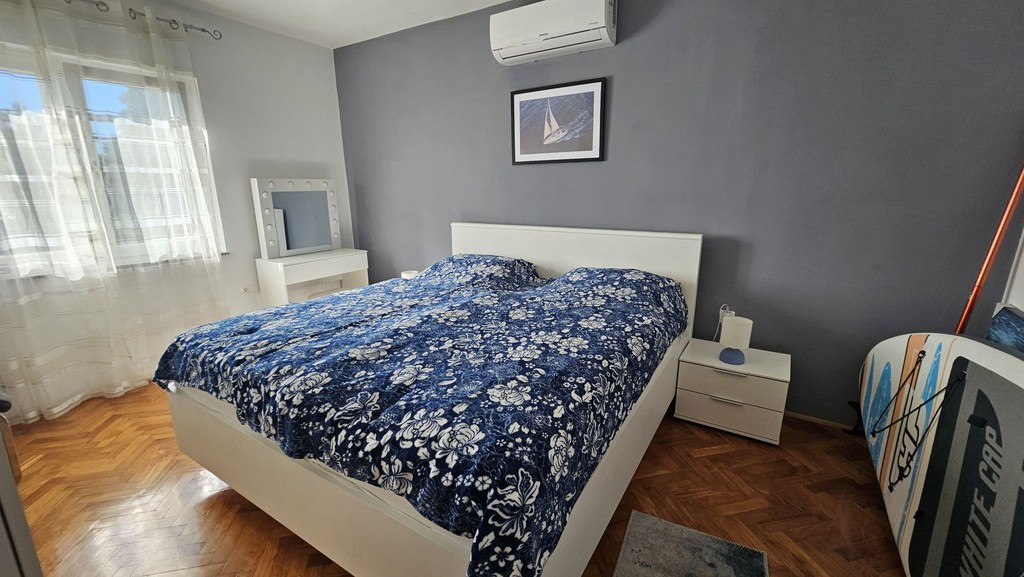 Bedroom with double bed and air conditioning unit