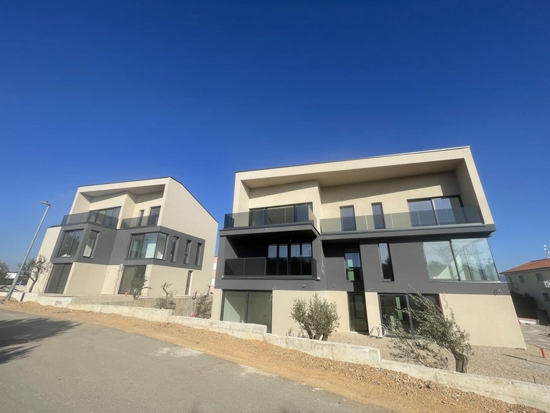 The two new-build buildings on the street