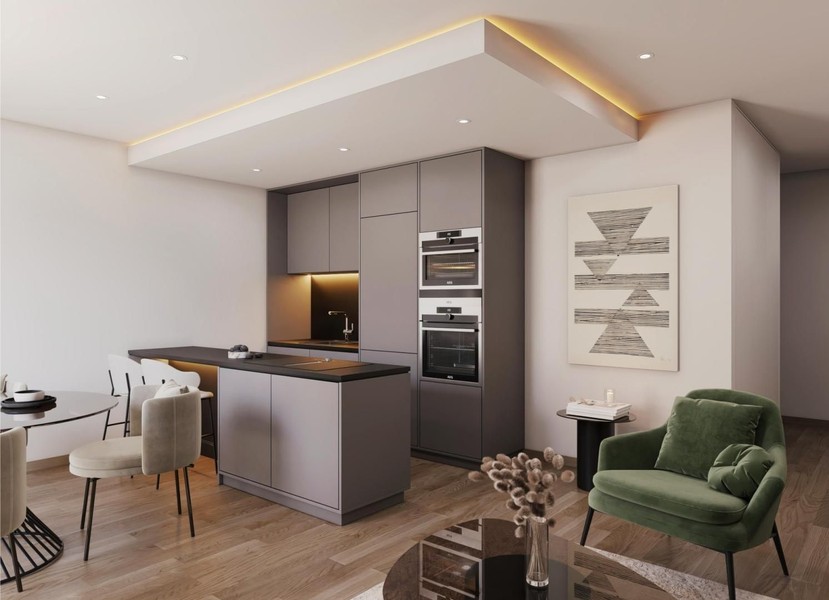 Open-plan kitchen with kitchen island and green armchair in the living area