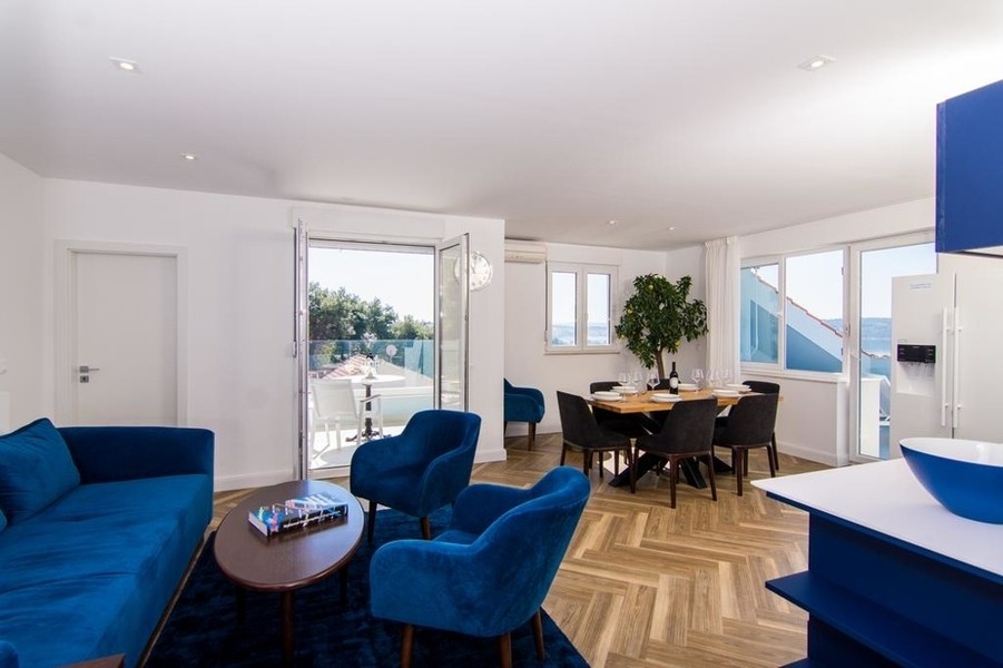 Living room with sofa corner and windows facing the sea