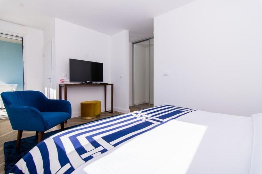 Bedroom with armchair and television