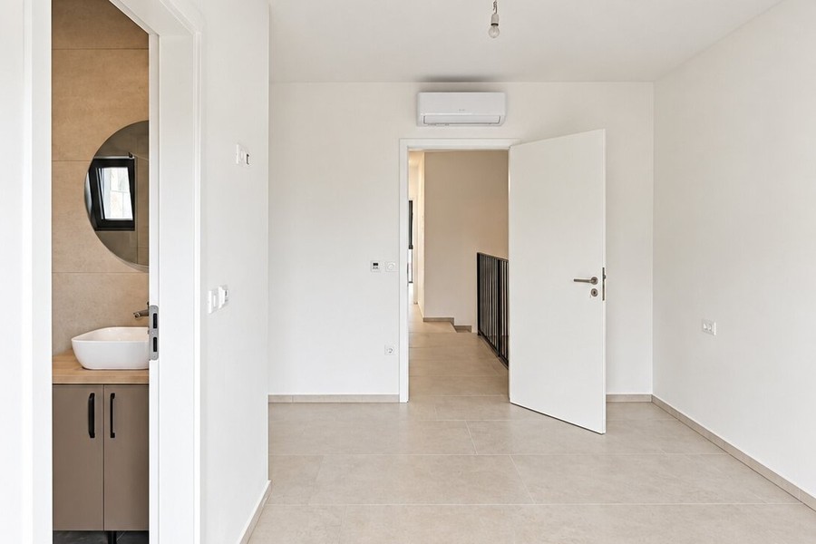 Bedroom with air conditioning unit and en-suite bathroom
