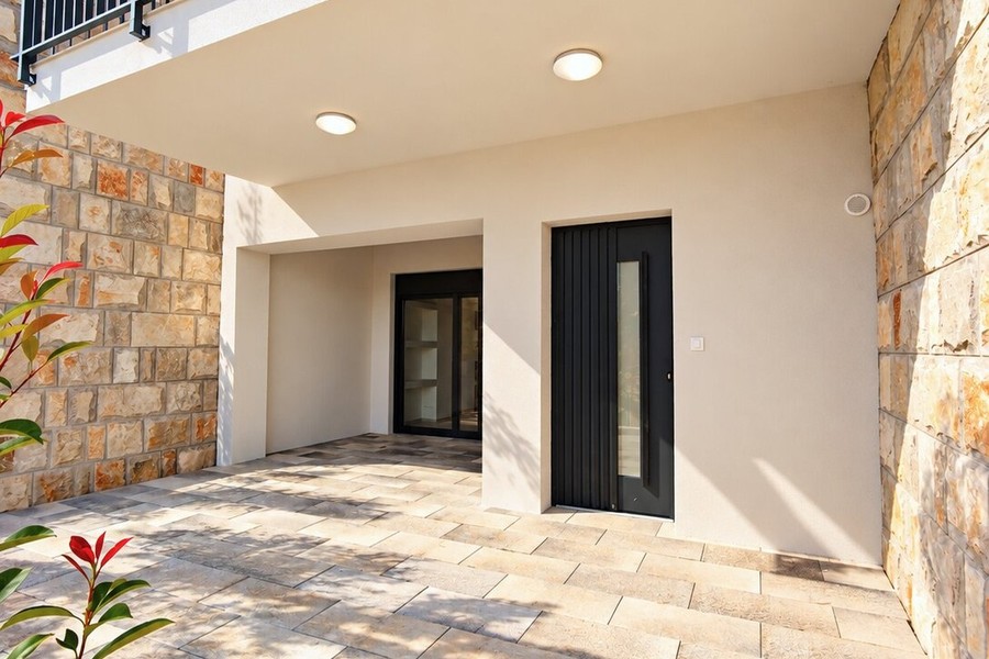 Covered entrance with natural stone wall