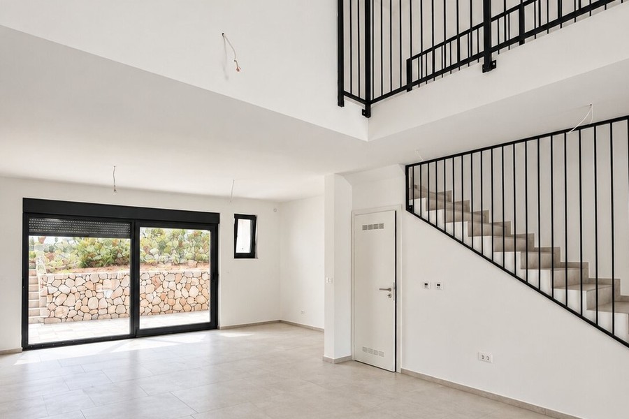 Living area with gallery and sliding door to the terrace