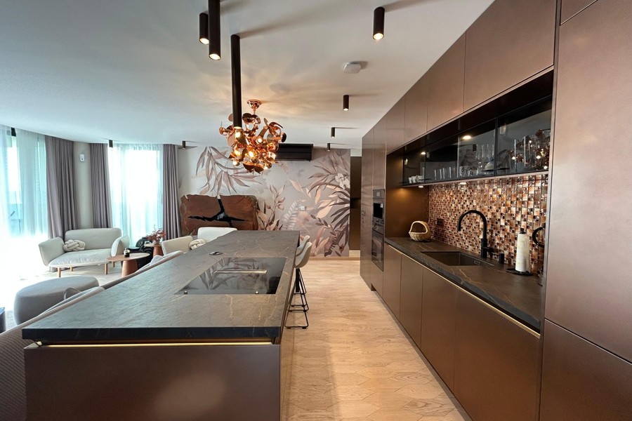 Bronze kitchen units with mosaic tiles
