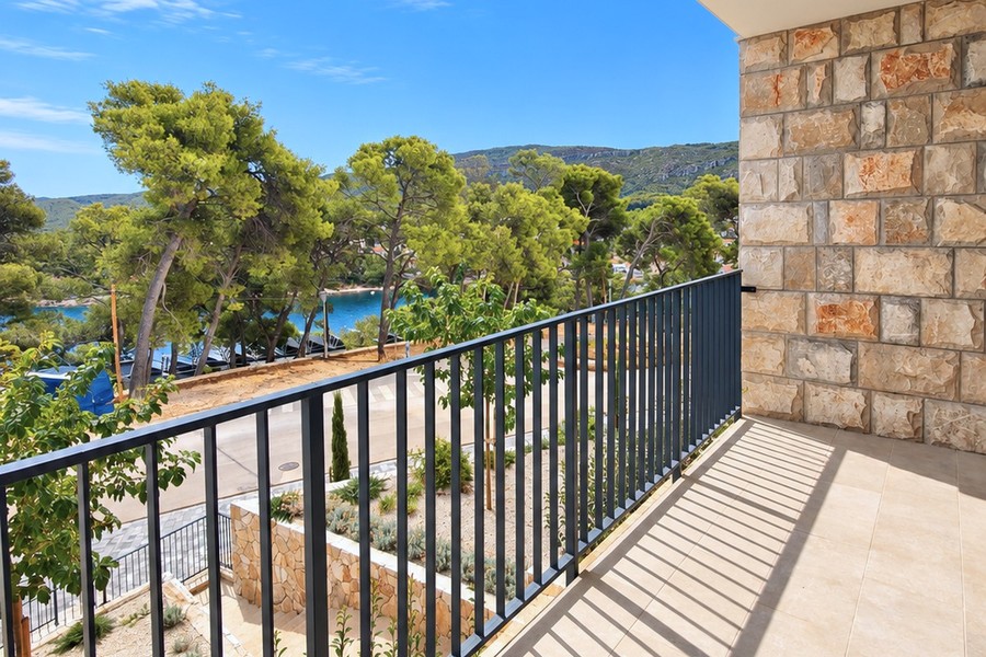 Balcony with view through the pines to the sea
