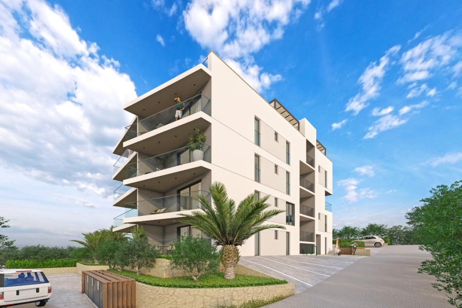 Building viewed diagonally from the driveway with outdoor parking spaces