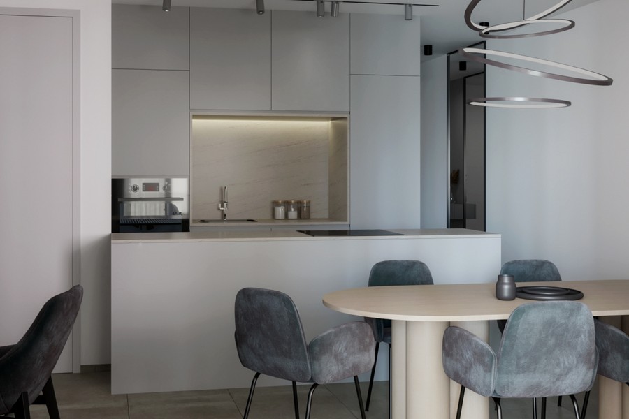 Open-plan kitchen with island and chairs at the dining table
