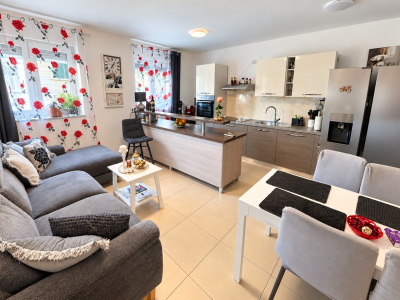 Living room with sofa and open kitchen