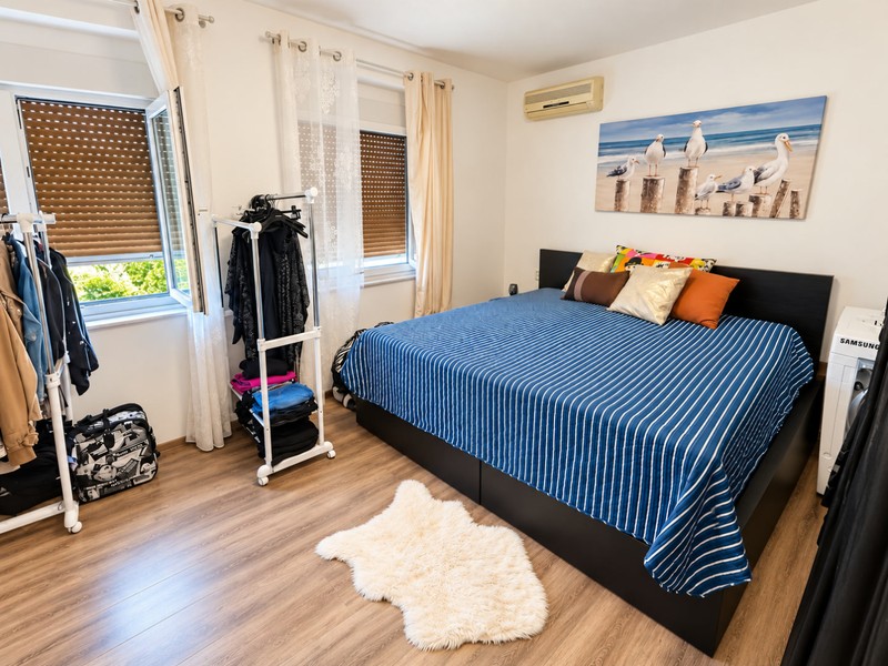 Bedroom with window and clothes rack