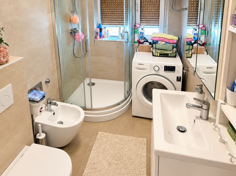 Bathroom with shower and washing machine