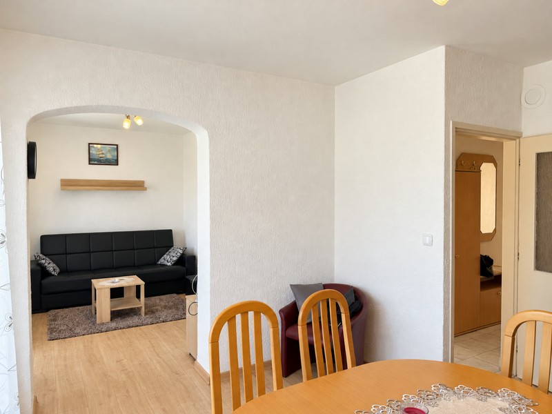 Living room with sofa and opening to dining area