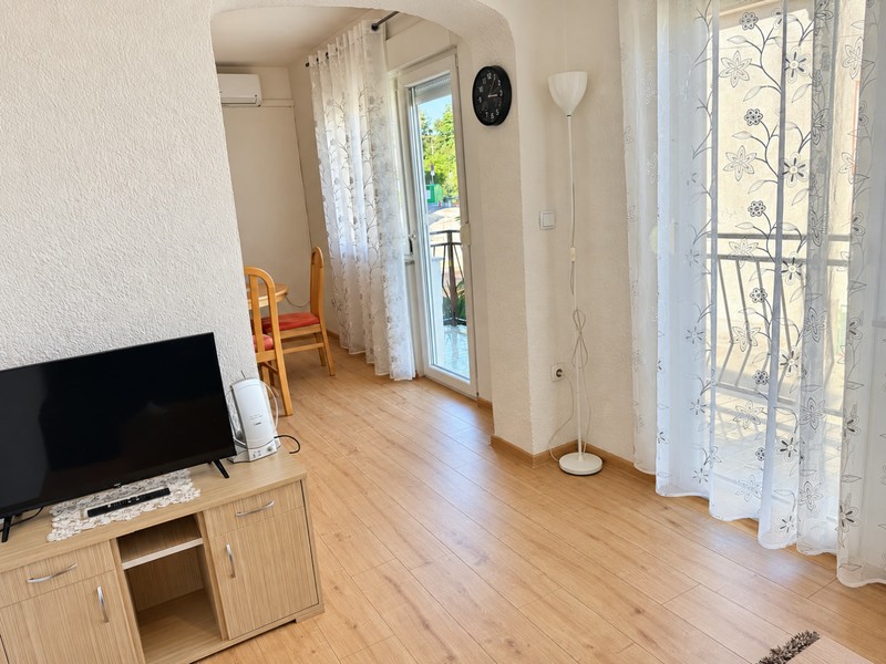 Living area with television and balcony door