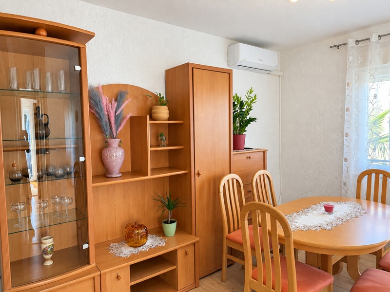 Dining area with display cabinet and round table