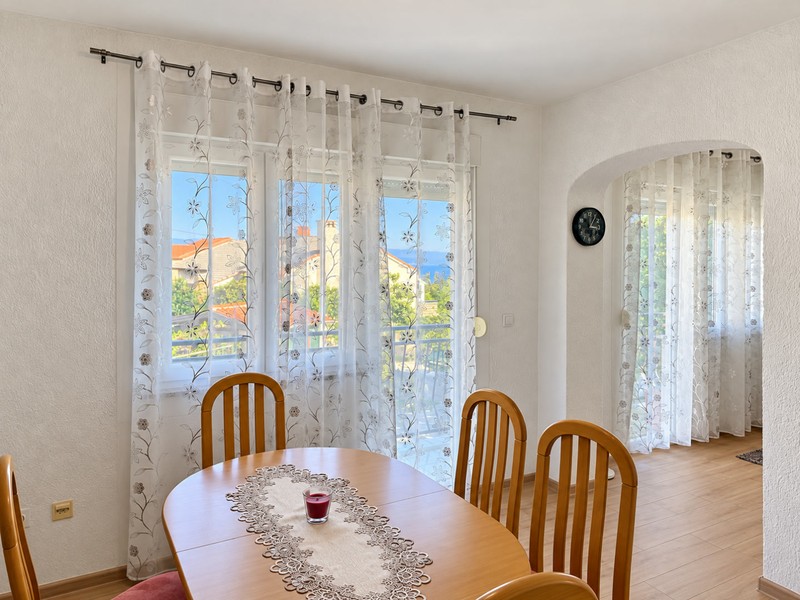 Dining table in front of large windows