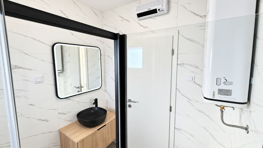 Bathroom with mirror and water heater