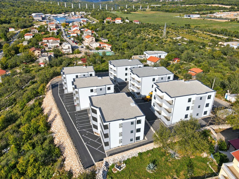 New buildings on the slope with parking spaces
