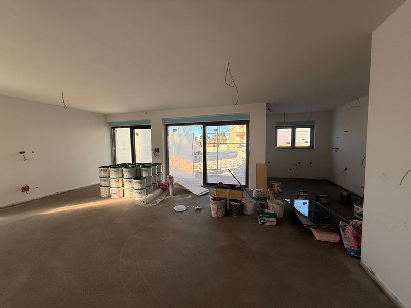 Living area with large window areas under construction