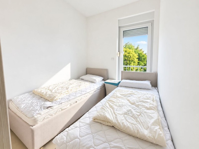 Room with single beds and window