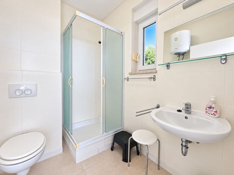 Bathroom with shower cubicle and water heater