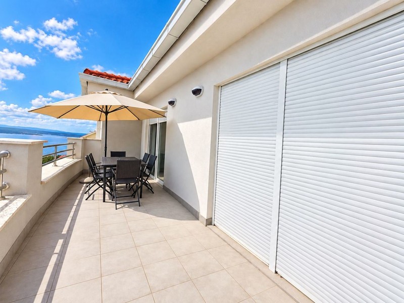 Sun terrace with parasol and dining table