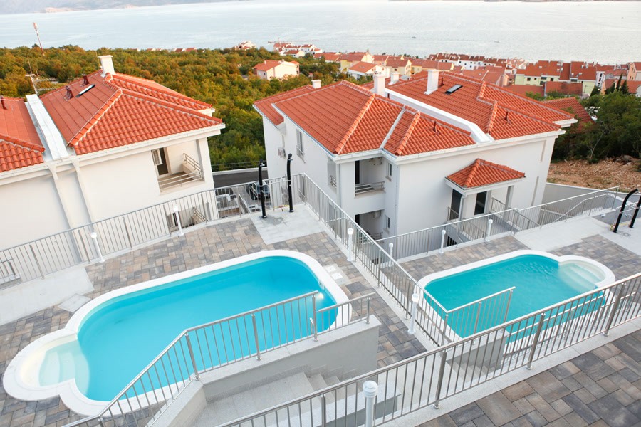 Residential complex with two pools seen from above